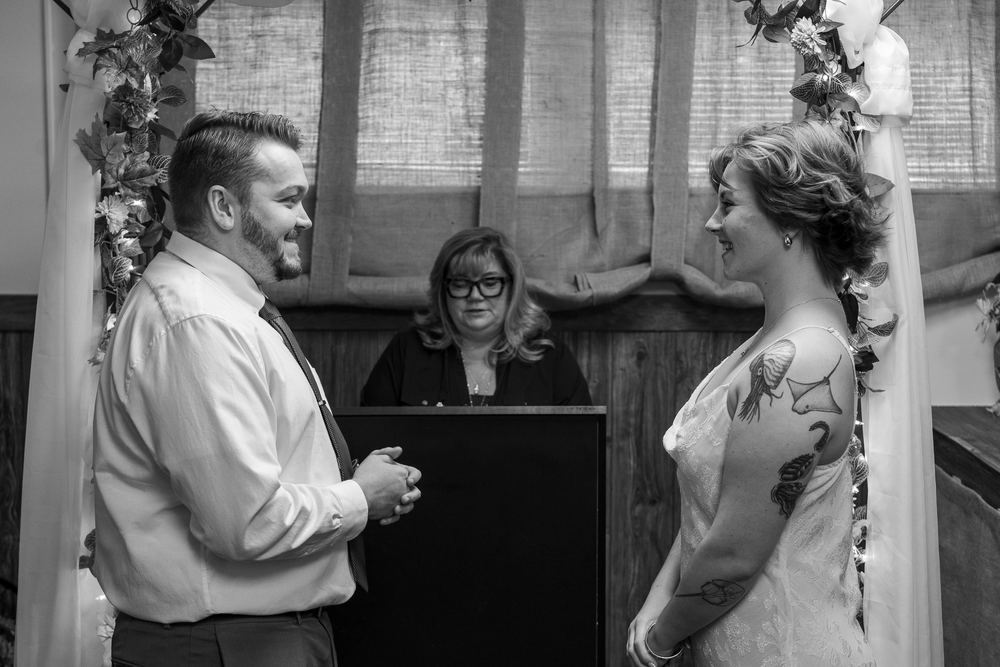 Black and white portrait of a bride and groom facing each other during their wedding ceremony, wedding photography by Campbell Shepard, Frederick, MD