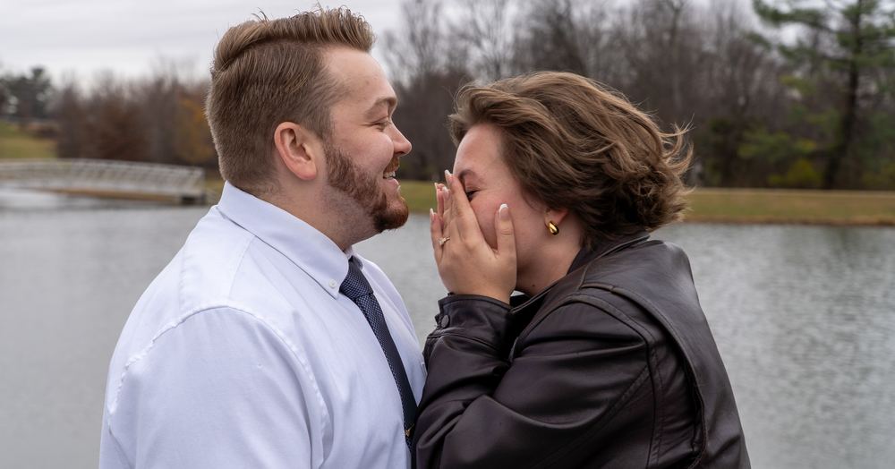 Newly engaged woman covering her face in happy surprise beside her partner, engagement photography by Campbell Shepard, Frederick, MD