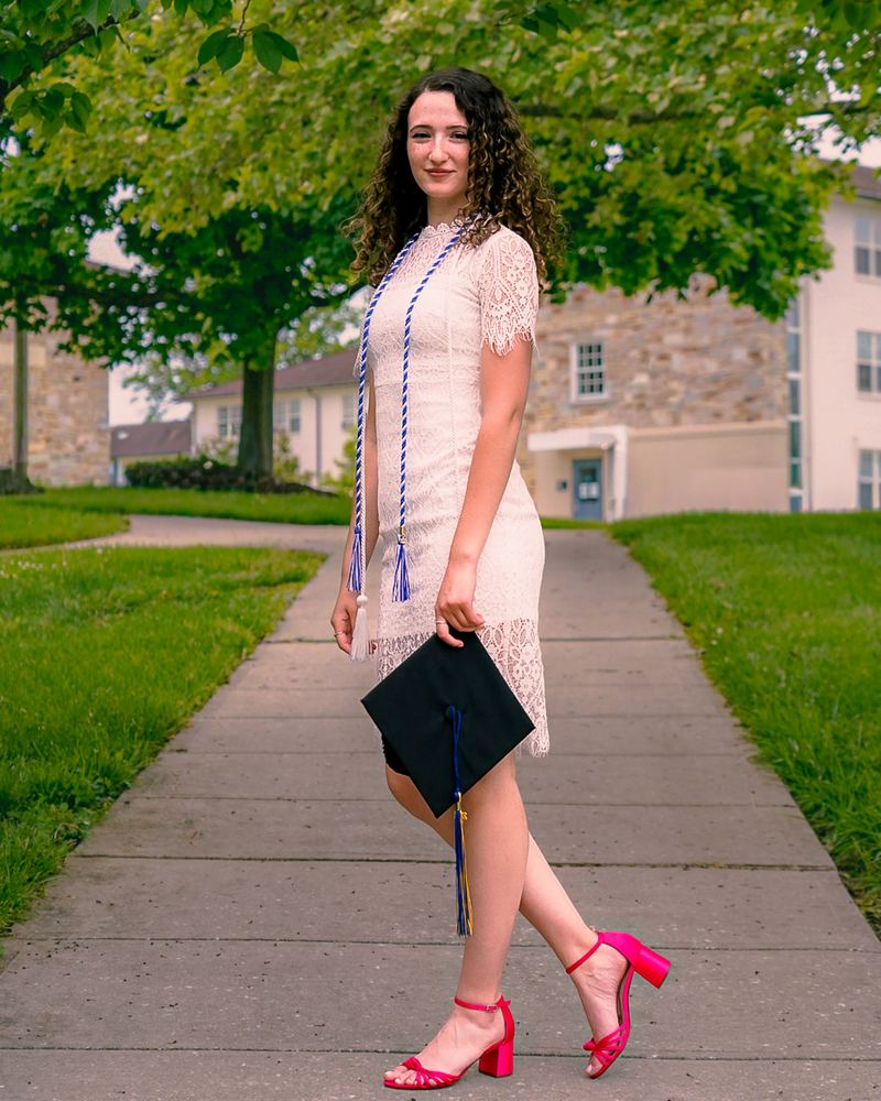 Senior portrait of Liora in a white dress on campus, graduation photography by Campbell Shepard, Frederick, MD photographer