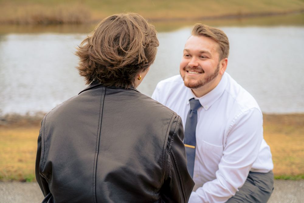 Candid moment between a couple by the water, man in a tie, wedding and couples photography by Campbell Shepard, Frederick, MD